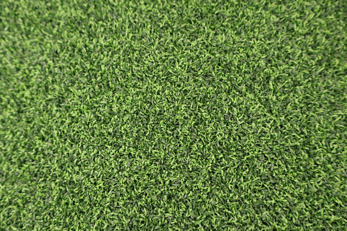 Green artificial turf texture with dense short grass blades filling the frame.